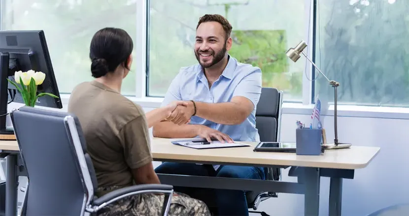 Military member meets with business professional